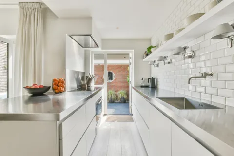 Kitchen with a light countertop and patterned backsplash